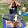Brandon holding Choco chocolate Chihuahua puppy with siblings outdoors on grass field