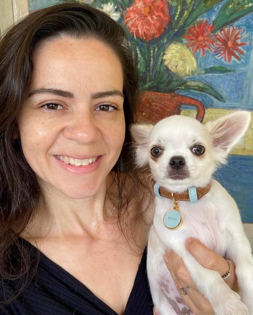 Woman holding her white male Chihuahua puppy from ChihuahuaHub.shop