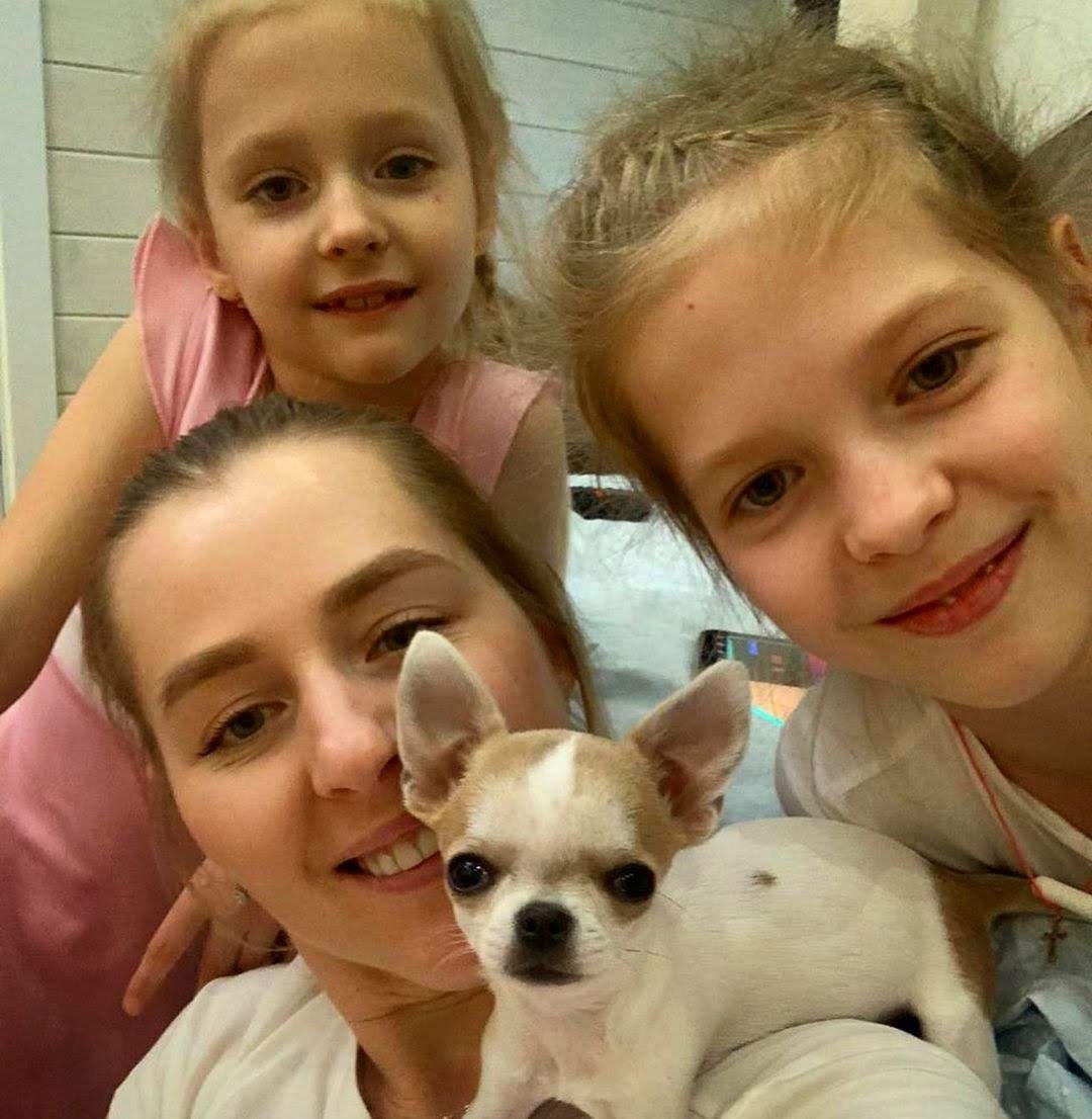 Happy family with two daughters and their new Chihuahua puppy from ChihuahuaHub.shop